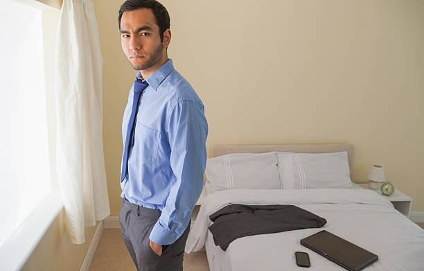 istock Irritated man looking at camera standing in front of window 503085923