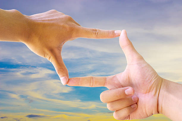 istock Photo sight:Frame made of hands with sunset sky 503086980