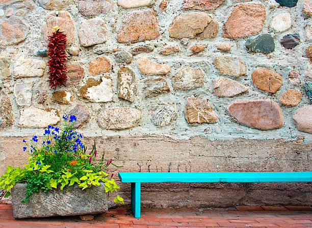 A string of dried chile peppers hangs on the rock wall in Santa Fe.