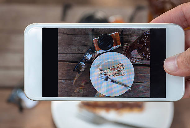 istock Banoffe cake, lemontea, eyeglass and camera on the wood 503087034