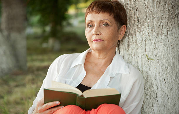 istock attractive woman 50 years old with a book 503087187