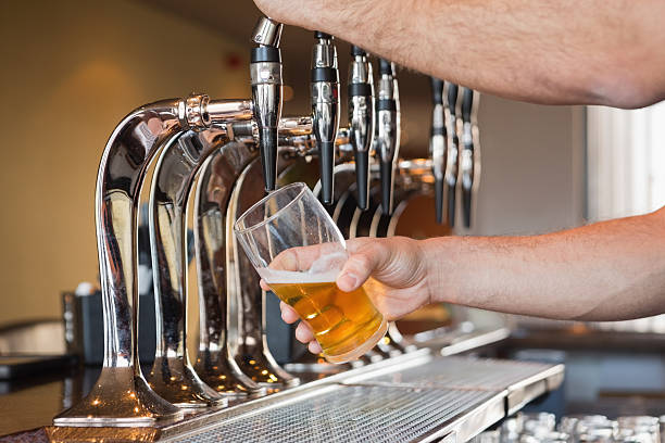 istock Mans hand pouring beer 503088293