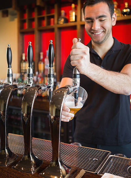 istock Handsome barkeeper pulling a pint of beer 503088297