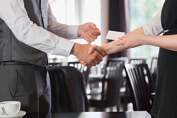 istock Busines people shaking hands after meeting and changing cards 503097435