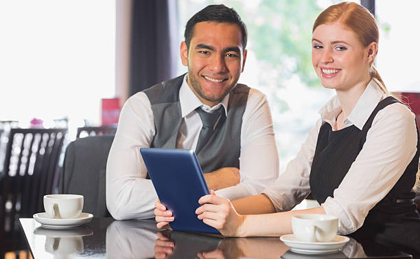istock Business team working on tablet pc together in a cafe 503097467