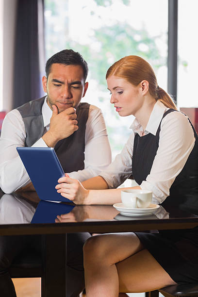 istock Business partners working on tablet pc together in a cafe 503097479