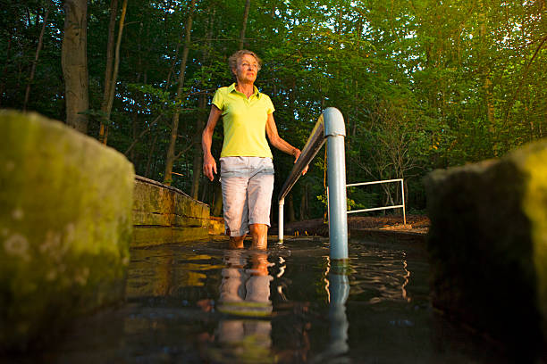istock senior woman taking a kneipp cur in a water basin 503098659