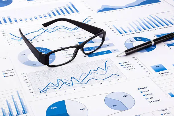 Photo of Blue business charts, graphs, document and paperwork