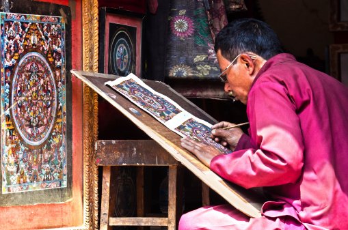 Bhaktapur, Nepal - April 5, 2014: Nepalese artist  creates traditional mandala painting.