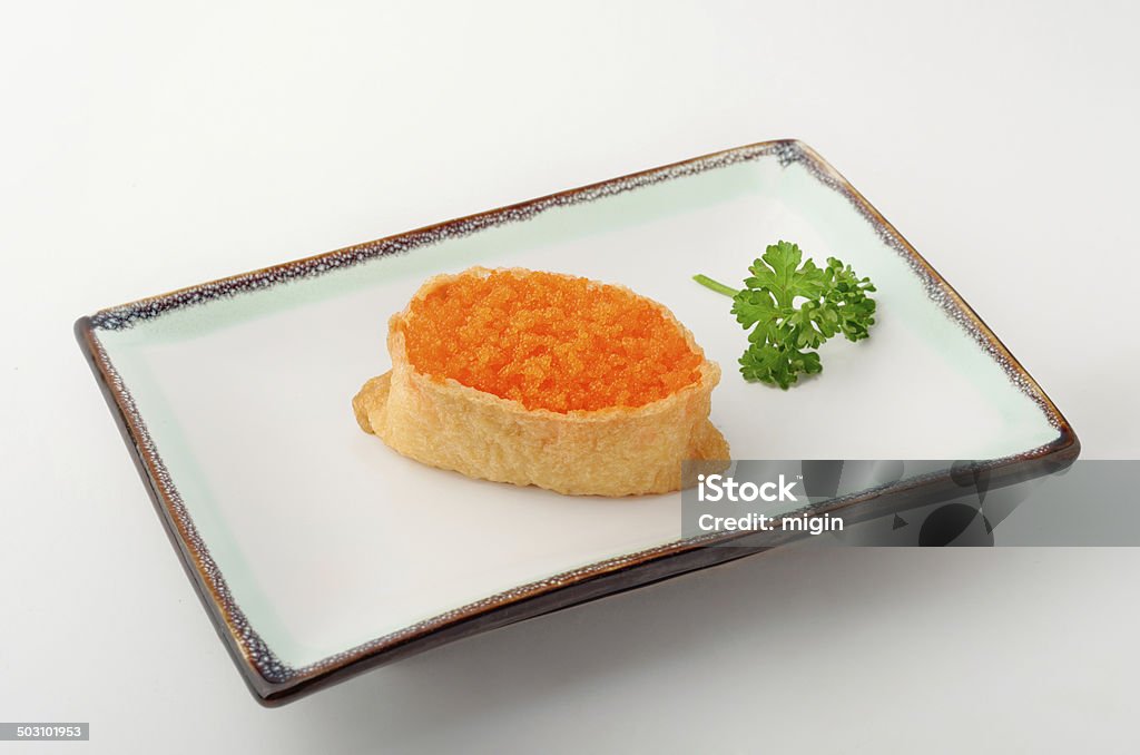 Aburage with fish eggs Sweet tofu skin pocket filled with sushi rice and topped with fish roe. Animal Egg Stock Photo