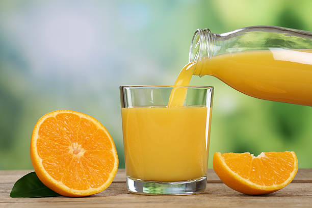istock Orange juice pouring into a glass in summer 503102581