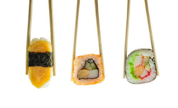 istock Sushi in chopsticks isolated on white background 503105550