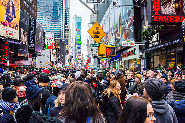 Big Crowd Times Square New York, NY, USA - December 23, 2015: A large crowd gathers in Times Square hours before the ball drops to ring in the New Year in New York City. times square new years eve stock pictures, royalty-free photos & images