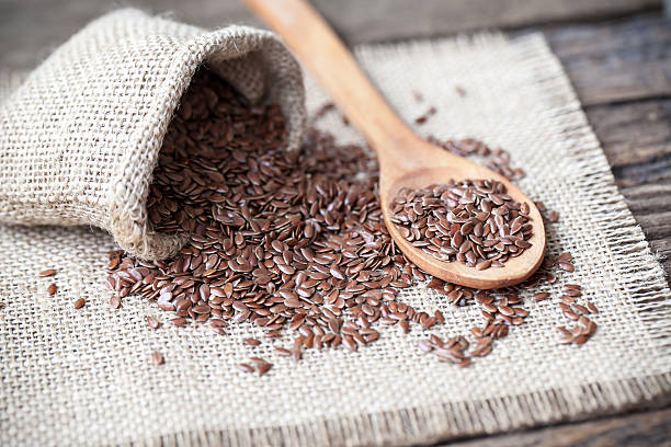 istock Flax seeds in the sack on wooden background 503107536