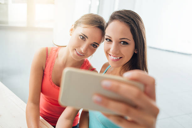 istock Cute girls taking selfies at home 503110416