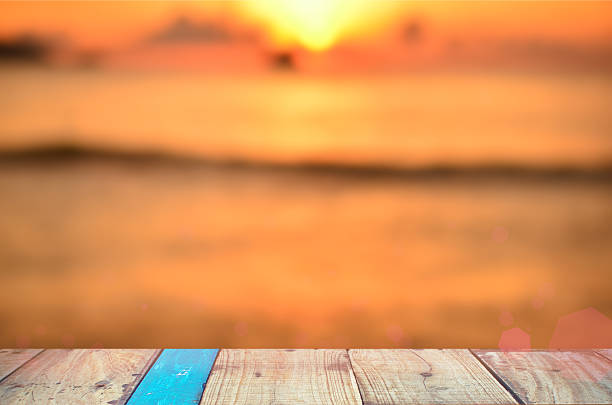 istock Blur tropical sunset beach with old empty wood table background. 503111714