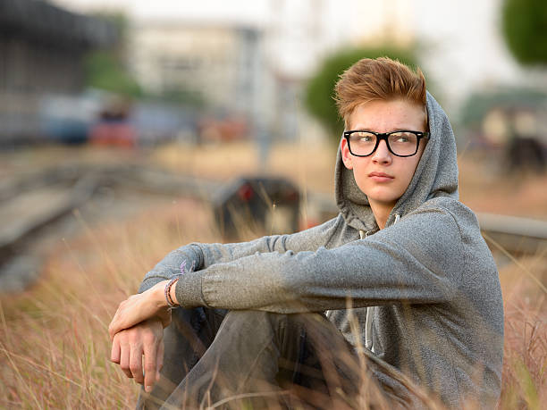 istock Teenager boy outdoors at train station 503112242