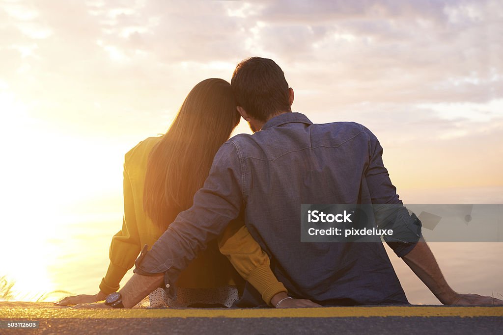Cross my heart A shot of a young couple looking at the sunset together 20-29 Years Stock Photo