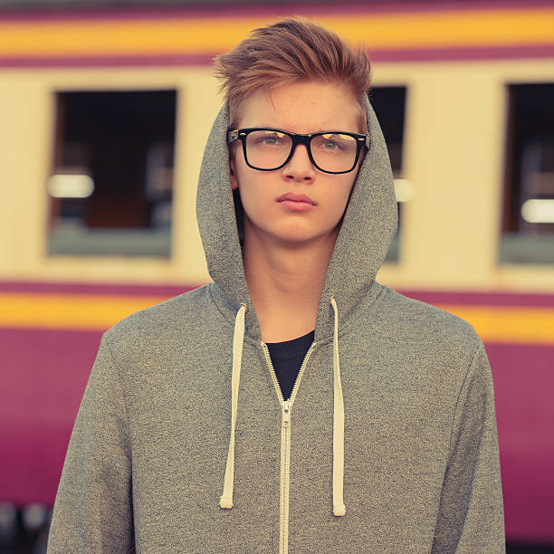 istock Teenager boy outdoors at train station 503112930
