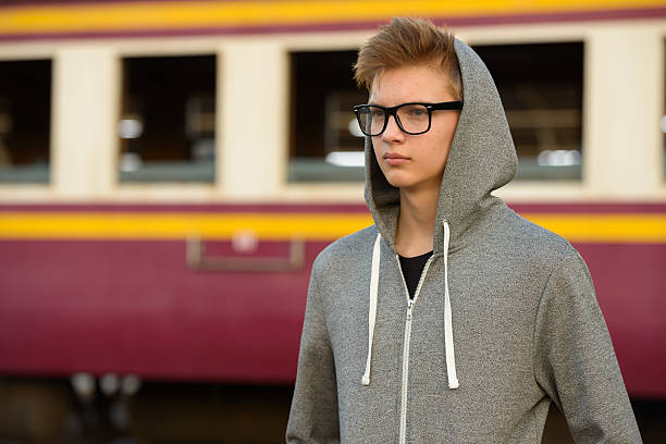 istock Teenager boy outdoors at train station 503113112