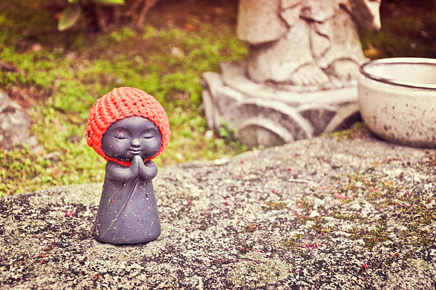 Miyajima, Japan - April 27, 2009: A jizo statue in the garden of Daisho-in temple, a historic Japanese buddhist temple on Mt.Misen on Miyajima Island in Hiroshima Prefecture.