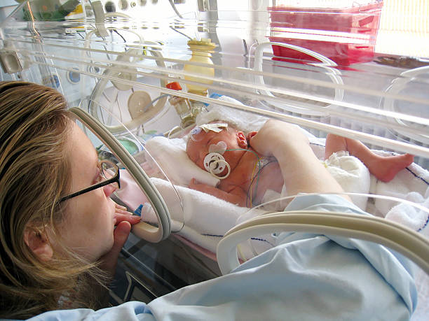 Newborn Premature in Incubator Newborn Premature in Incubator incubator stock pictures, royalty-free photos & images