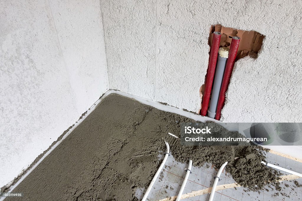 Finishing Concrete Layer of fresh mortar on radiant Floor Heat System. Construction Site Stock Photo
