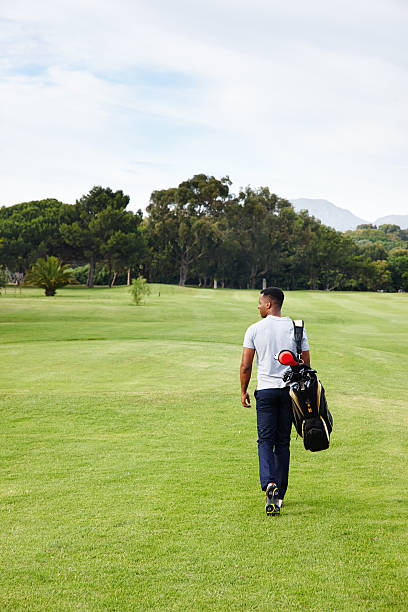 A golfer uses the latest technology in artificial intelligence using his glasses to hit a shot with his golf club