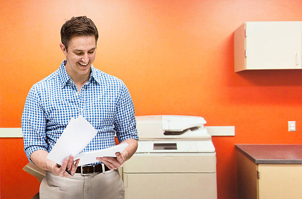 Smiling businessman working in officehttp://www.twodozendesign.info/i/1.png
