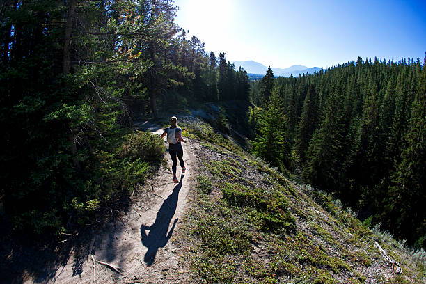 A woman competes in a long distance trail running race in Alberta, Canada.