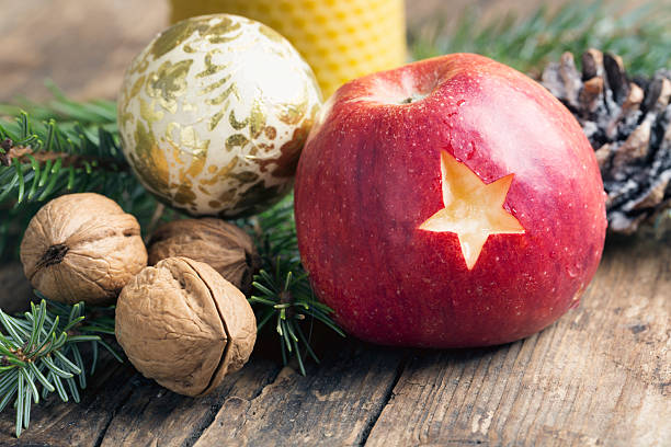 christmas apple with star on rustic wood