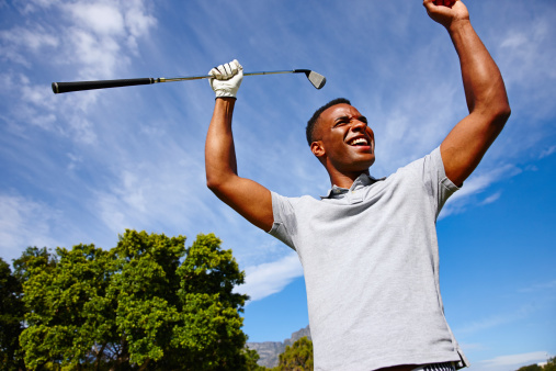 Shot of a young man celebrating his golf shot