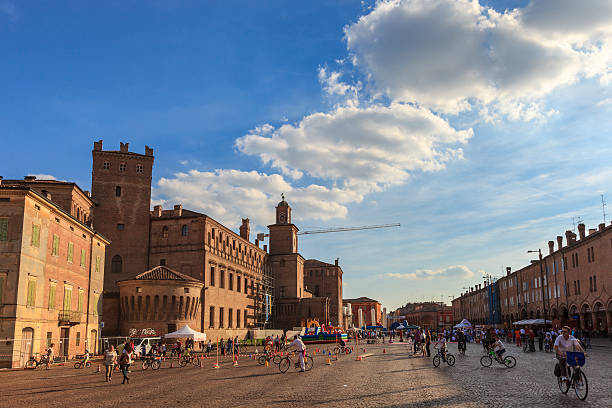 Carpi, Italy - September 22, 2013: People stroll in the big Piazza dei Martini in a Sunday of September, while children enjoy the outdoor games.
