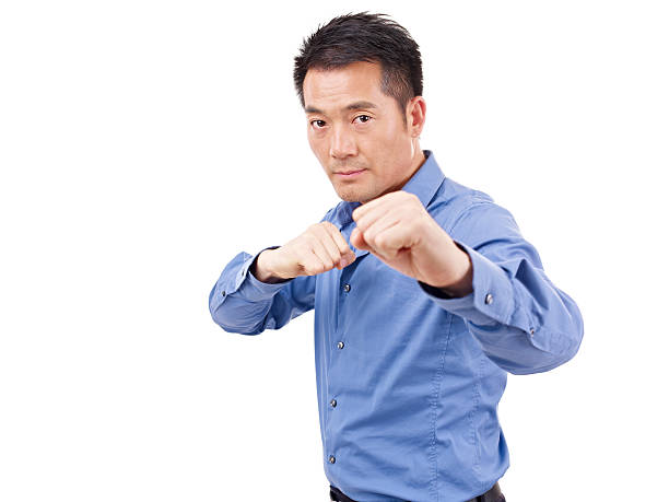 istock asian businessman showing karate move 503117915