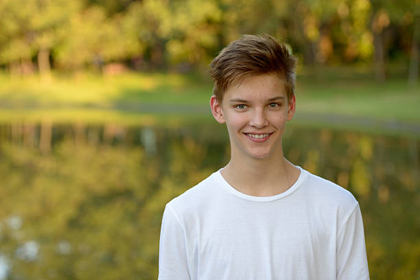 istock Teenager boy smiling outdoors in park 503118008