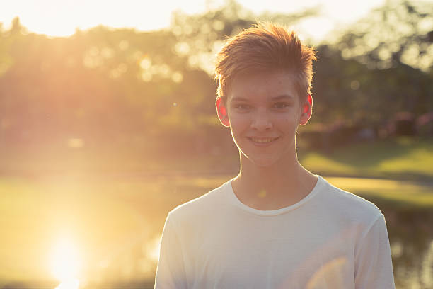 istock Teenager boy smiling outdoors in park 503118074