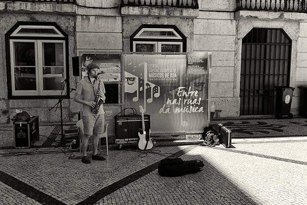 Lisbon, Portugal - July 15, 2014: A street musician plays a saxophone in the Rua Augusta in Lisbon downtown.