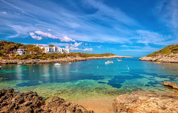 Beautiful seascape, sailing boats and several beaches in the bay of the port of Portinatx, located in the north of Ibiza (Spain)