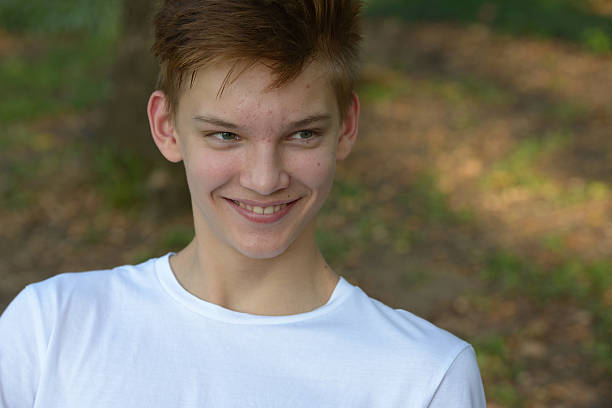 istock Teenager boy smiling outdoors in park 503119242