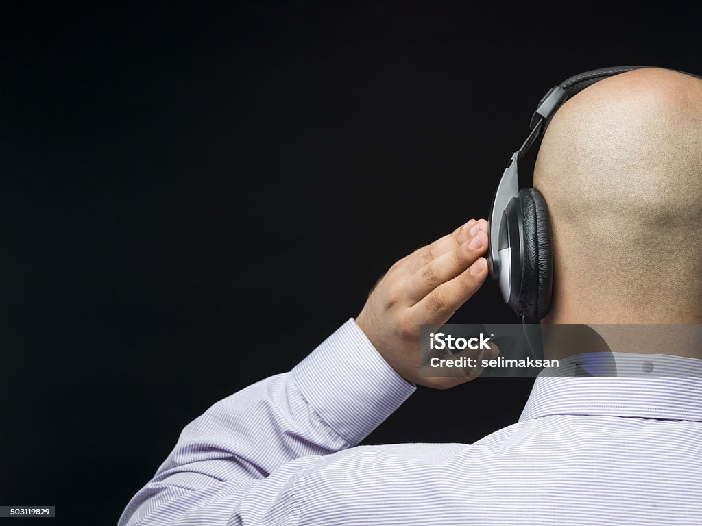 Baldheaded man with headphone Back Stock Photo