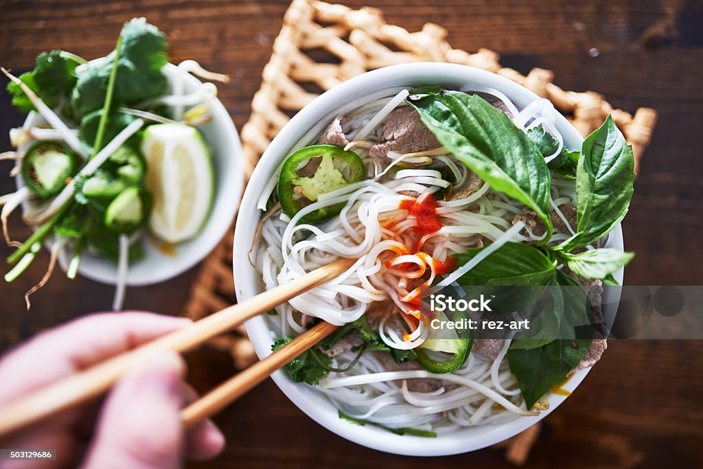 vietnamese pho with spicy sriracha sauce shot top down Pho Soup Stock Photo