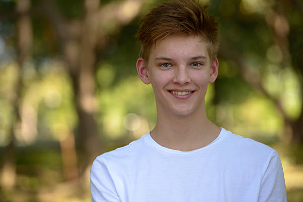 istock Teenager boy smiling outdoors in park 503129918