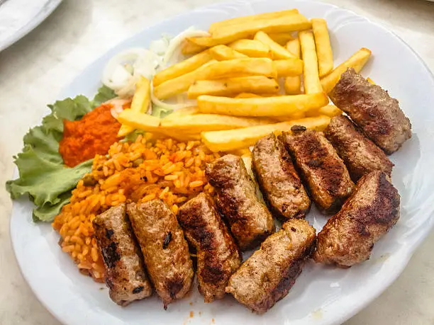 Cevapcici Platter with French Fries, Rices and Ajvar.