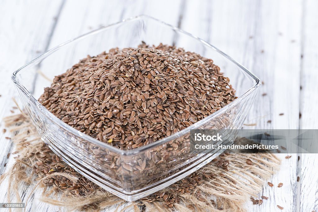 Bowl with Linseeds Bowl with Linseeds (close-up shot) on vintage wooden background Agriculture Stock Photo