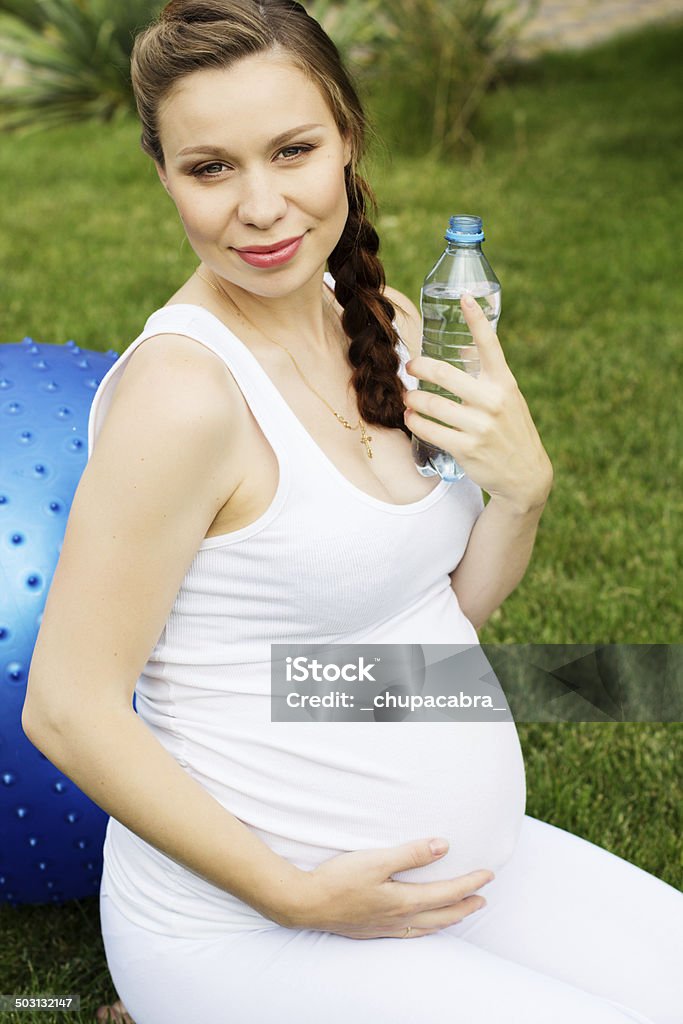 Beautiful pregnant woman relaxing in the park Beautiful pregnant woman doing sport in park Abdomen Stock Photo