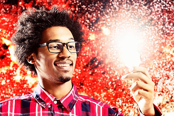 Smiling young astrophysicist with ball of light