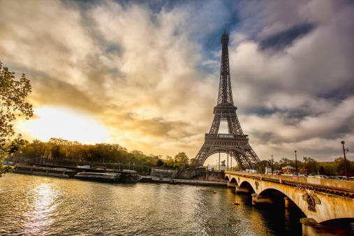 Spring morning with Eiffel Tower against boat and bridge in Paris, France