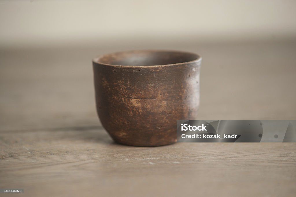 Traditional handcrafted dish Traditional handcrafted dish of brown color on the table Art Stock Photo