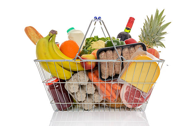 Shopping basket full of fresh food isolated on white. stock photo