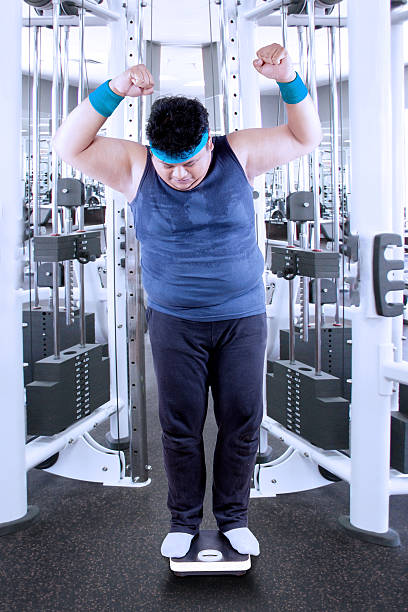 istock Fat man measure his weight 1 503134815